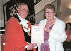 Pam Stevens receiving her award from the Mayor. Click for larger image